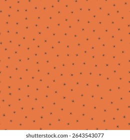 Ditsy Halloween seamless pattern with silhouette spiders. Vector hand drawn illustration. Tiny black arachnids on orange background.October fall holidays backdrop for packaging, print. Creepy crawlies