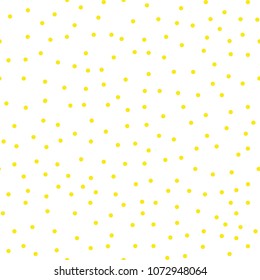 Ditsy vector polka dot pattern with scattered hand drawn small circles in yellow gold and white colors. 