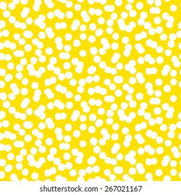 Ditsy vector polka dot pattern with scattered hand drawn small circles in bright yellow and white. Seamless texture in vintage 1950s fashion style. Modern hipster background with painted round shapes