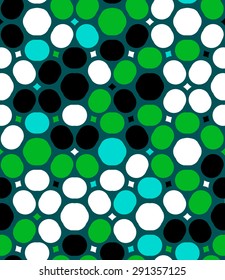 Ditsy vector polka dot pattern with random circles in bright multiple colors on green background. Seamless texture in vintage 1960s fashion style. Modern hipster design with round shapes