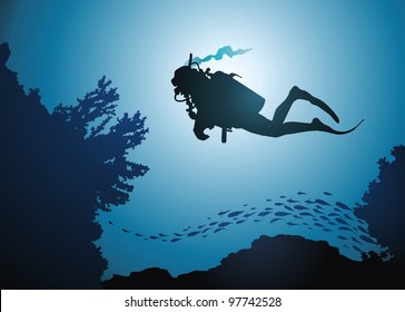 The diver floats among corals and fishes