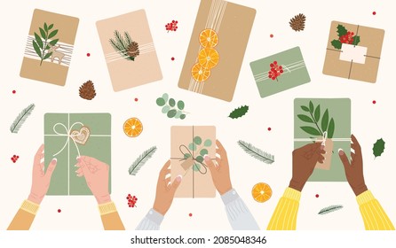 Diversity female hands hold gift boxes wrapped into kraft paper. Top view eco-friendly packaging, dry orange, red berries, pine cones, greens. Eco Christmas concept. Hand drawn vector illustration