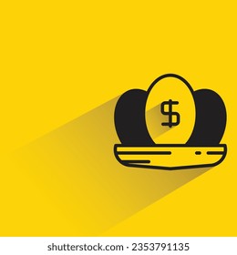 dividend egg on nest with shadow on yellow background