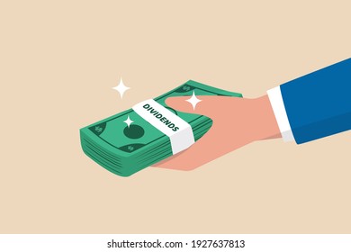 Dividends stock payment, passive income from dividend yield concept, rich and wealthy businessman hand holding pile of dollar money banknotes with the word Dividends.