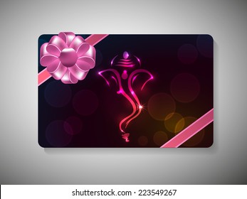 Diwali festival gift card with shiny face of Lord Ganesha and ribbon decoration on stylish background.