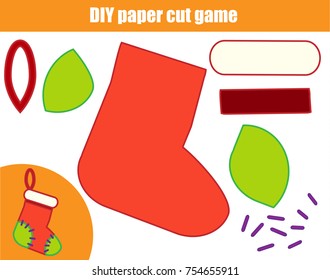 DIY children educational creative tutorial game. Paper cutting activity. Make a New Year, Christmas sock with glue and scissors