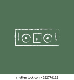 DJ console hand drawn in chalk on a blackboard vector white icon isolated on a green background.