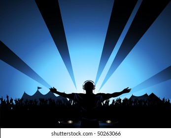 DJ playing to crowd at outdoor summer festival