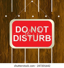 DO NOT DISTURB sign hanging on a wooden fence