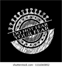 Do not fear your fear chalk emblem written on a blackboard