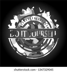 Do it yourself written on a grey camouflage texture
