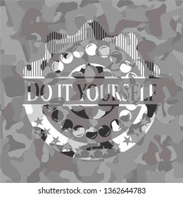 Do it yourself written on a grey camouflage texture