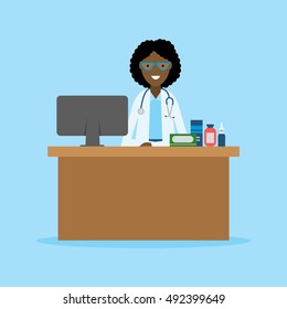 Doctor in the cabinet. Funny smiling female african american doctor sitting in the medical cabinet. Medical treatment, first aid.