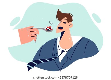 Doctor hand with pills near man opening mouth to take medicine from spoon, for concept medicaments abuse. Man takes too many medicaments and antibiotics, wanting to get better quickly