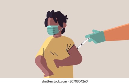 doctor hand vaccinating african american boy patient in medical mask fight against coronavirus vaccine development