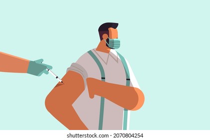 doctor hand vaccinating male patient in medical mask fight against coronavirus vaccine development concept
