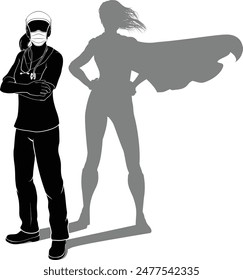 A doctor or nurse woman in silhouette wearing PPE mask and scrubs revealed as a super hero by her shadow.