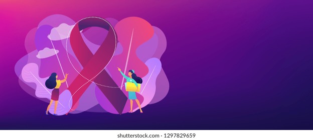 Doctor showing breast cancer awareness ribbon to the female patient. Breast cancer, women oncology factor, breast cancer prevention concept. Header or footer banner template with copy space.