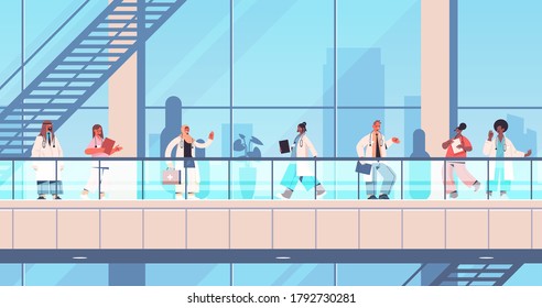 doctors in uniform standing together mix race medical workers team discussing during meeting healthcare medicine concept hospital building exterior horizontal full length vector illustration