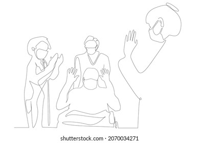 The doctors, who gave moral support to the recovered patient who survived his illness, applaud. The patient who recovered from the corona virus epidemic disease is taken with a wheelchair