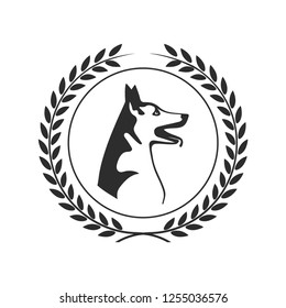 Dog head symbol in a laurel wreath.