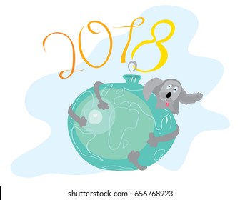 The dog hung on a toy ball depicting the earth / happy new year 2018