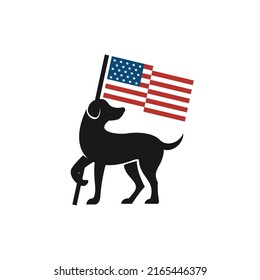 dog looking back and holding american flag
