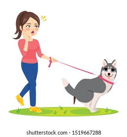 Dog making poo on grass and woman surprised