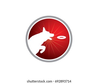 Dog training center logo. Dog silhouette jumping and almost catching an object on a round background in red