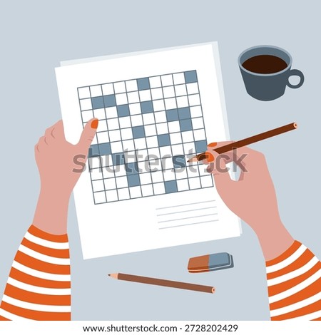 Doing crosswords at the table with a cup of coffee.