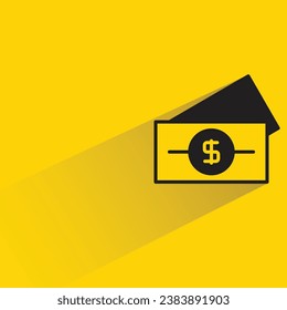 billete en dólares con sombra sobre fondo amarillo