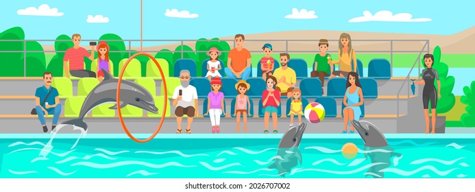 Dolphin showing trick, jumping through hoop in dolphinarium. Dolphin plays, does tricks for spectators. Show on water, performance in oceanarium. Viewers watch marine mammal performing in pool