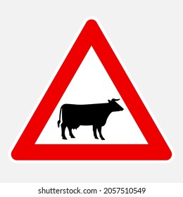 Domestic animals (cow black silhouette) ahead vector danger road sign