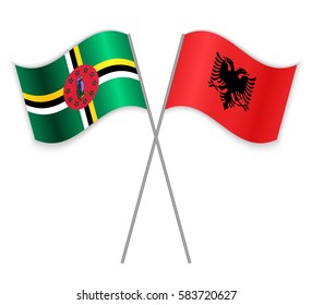 Dominican and Albanian crossed flags. Dominica combined with Albania isolated on white. Language learning, international business or travel concept.