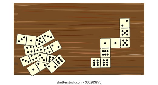 Dominoes game spread on a wooden board
