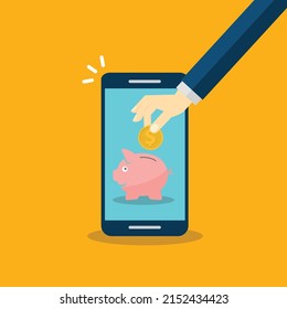 Donación, concepto de donación. Mano humana con moneda de oro y banco de cerdos en el teléfono móvil.
