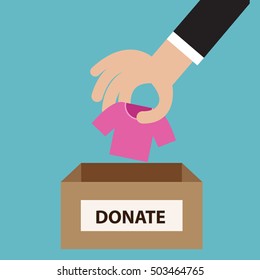 Donation concept. Hand putting cloth to donate box