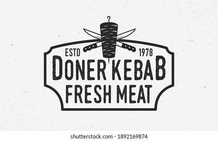 Doner Kebab vintage logo. Doner Kebab with kebab knives and vintage frame. Emblem template for barbecue, grill, restaurant design. Vintage hipster design with grunge texture. Vector illustration