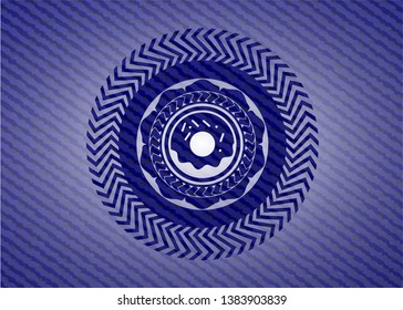 donut icon inside badge with denim background
