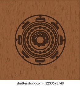 donut icon inside badge with wood background