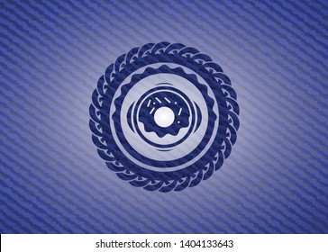 donut icon inside emblem with denim texture