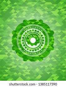 donut icon inside green emblem with triangle mosaic background