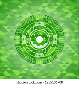 donut icon inside green mosaic emblem
