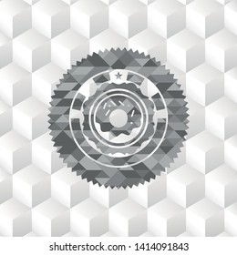 donut icon inside grey badge with geometric cube white background