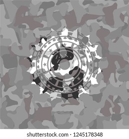 donut icon inside grey camo emblem
