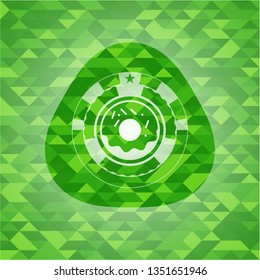 donut icon inside realistic green emblem. Mosaic background