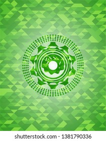 donut icon inside realistic green mosaic emblem