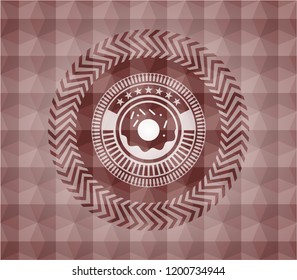 donut icon inside red seamless badge with geometric pattern.