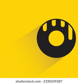 donut with shadow on yellow background