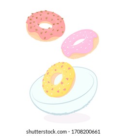 Donuts with colored icing fall into the plate